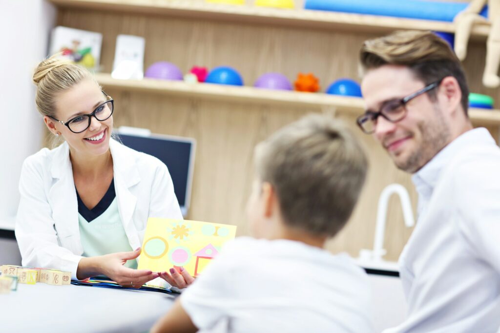 Child psychologist working with family in office