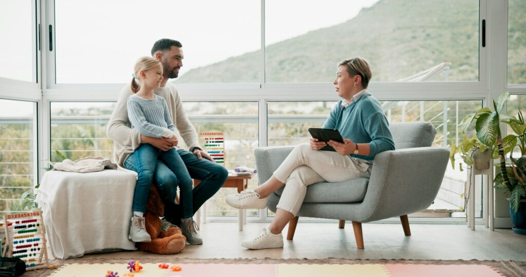 Father, child and woman with tablet in office for psychology consultation, therapy session and lear